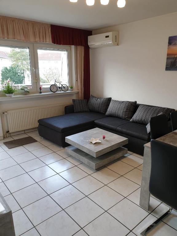 a living room with a couch and a table at Ferienwohnung Calabria Nr 2 in Mülheim an der Ruhr
