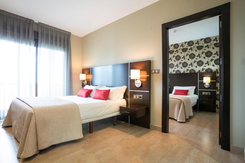 Postel nebo postele na pokoji v ubytování Hotel Piramide 2