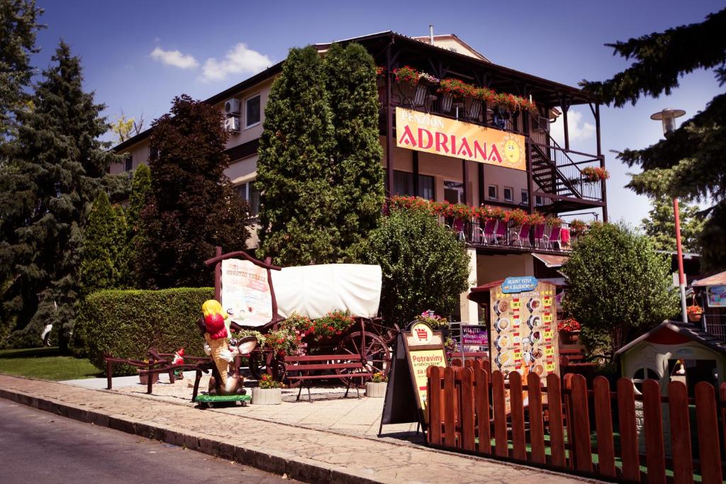 a building with a sign that says an amazon at Penzion Adriana in Patince