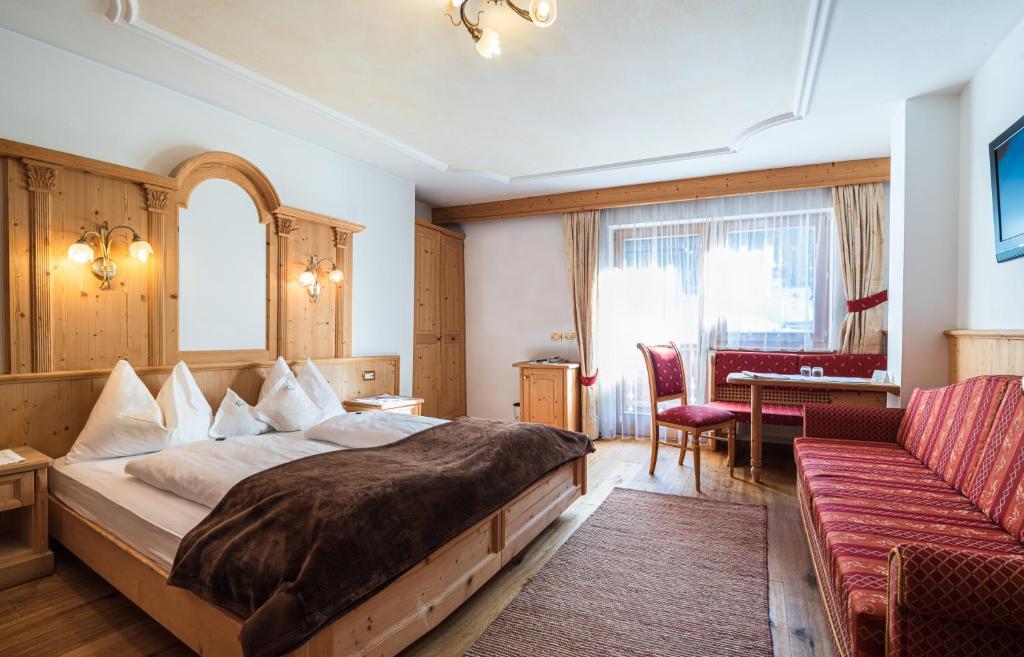 Postel nebo postele na pokoji v ubytování Garni Hotel Rosengarten B&B