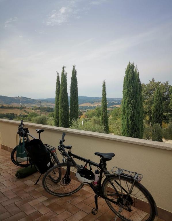 two bikes parked on a balcony with a view at Casale Terre Rosse in Saturnia