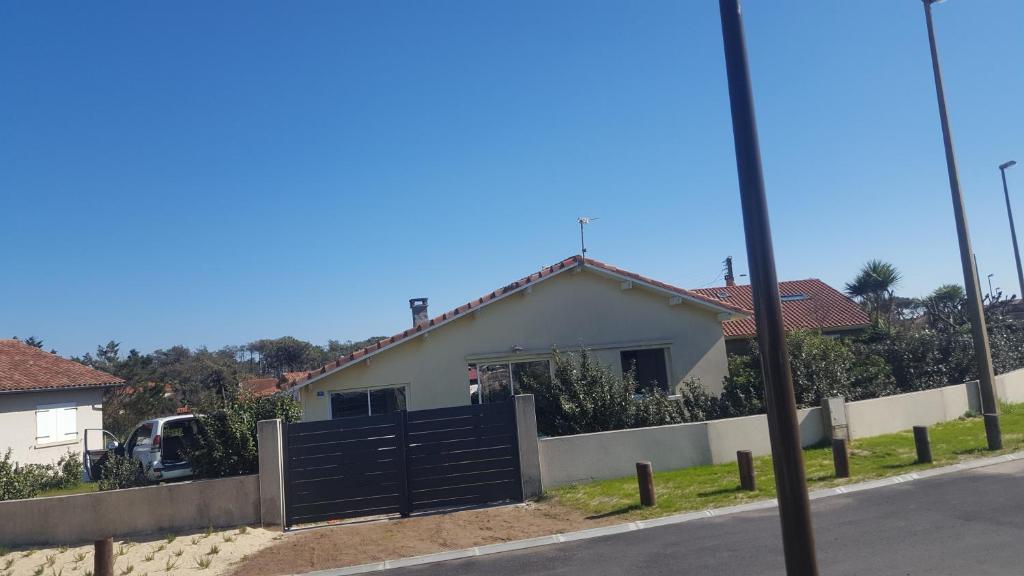 a house with a black gate and a fence at villa l atlantide in Vieux-Boucau-les-Bains