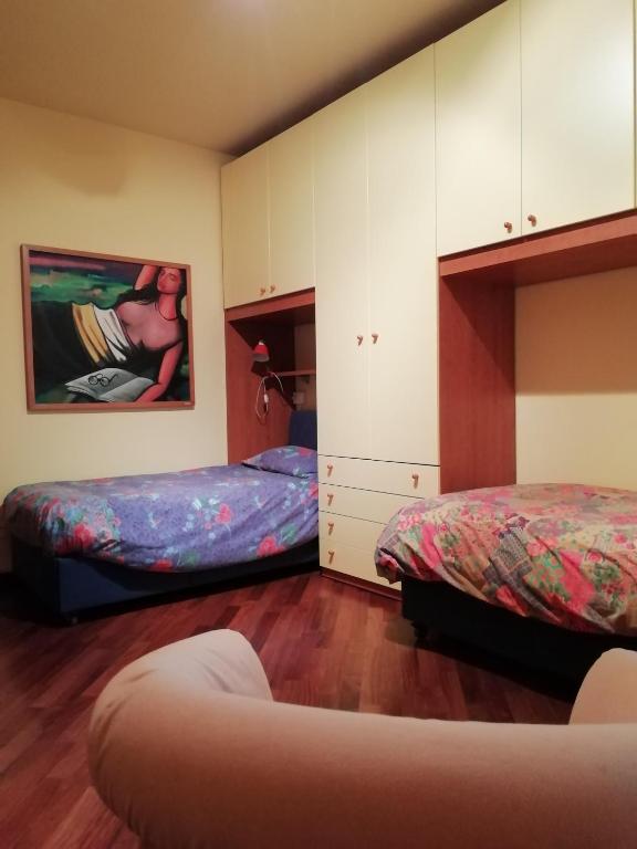 sypialnia z 2 łóżkami i szafką w obiekcie LovelyWillyhome w mieście Desenzano del Garda
