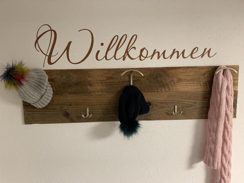 a wooden sign with the word wilderness hanging on a wall at Ferienhaus "frainerei" in Klösterle