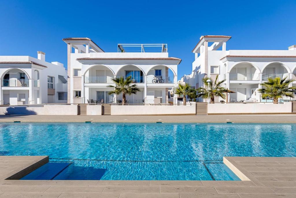 a villa with a swimming pool in front of a building at Fortuna -7/1 in Rojales