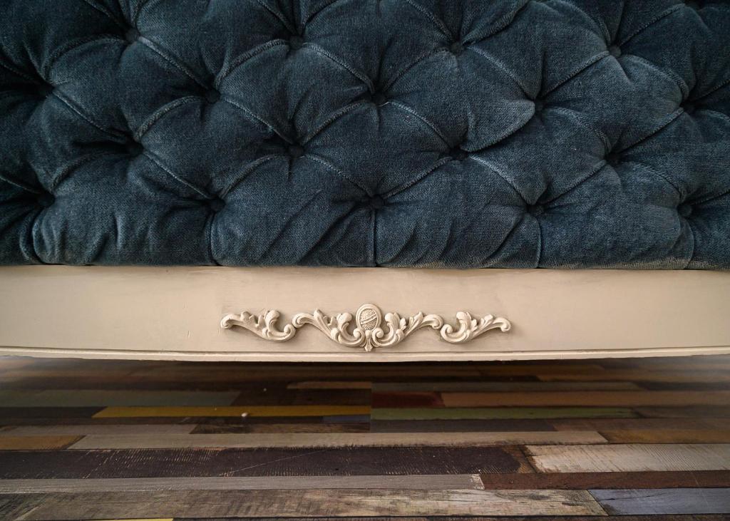 a blue couch with a silver design on it at Center Retro Apartment in Niš