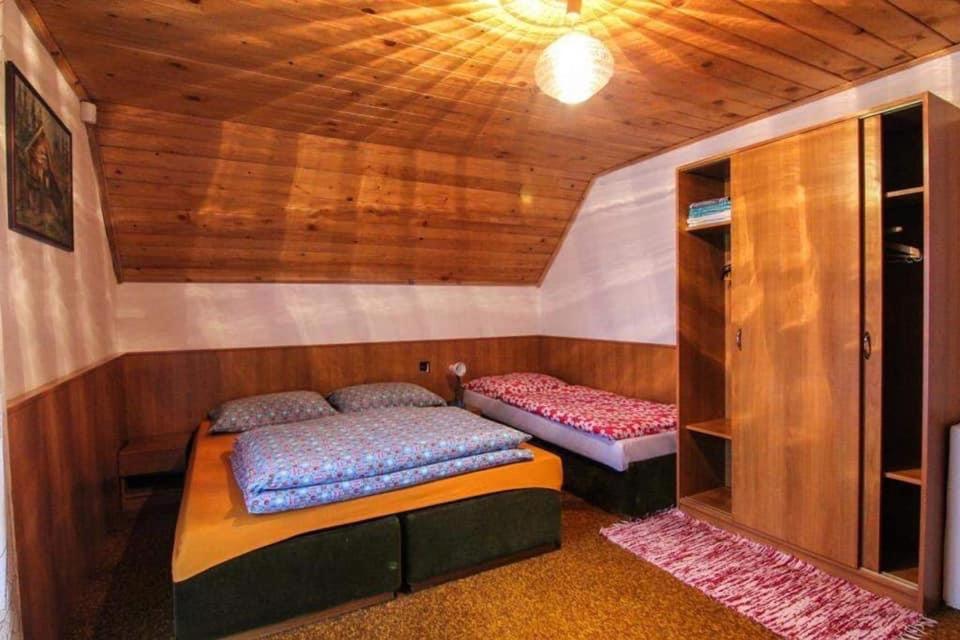 a room with two beds in a small room at Chata Lenka in Štrba
