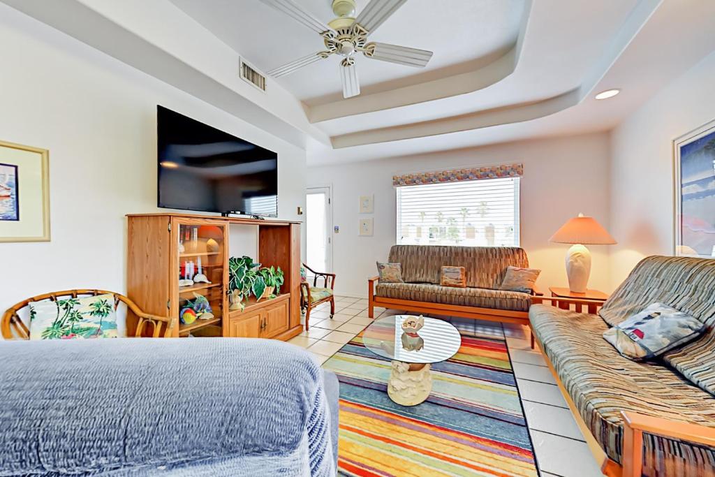 a living room with a bed and a couch at Marlin Street Tomehome A in South Padre Island