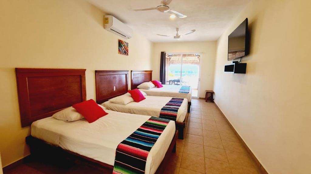 Postel nebo postele na pokoji v ubytování Hotel Machos Mahahual