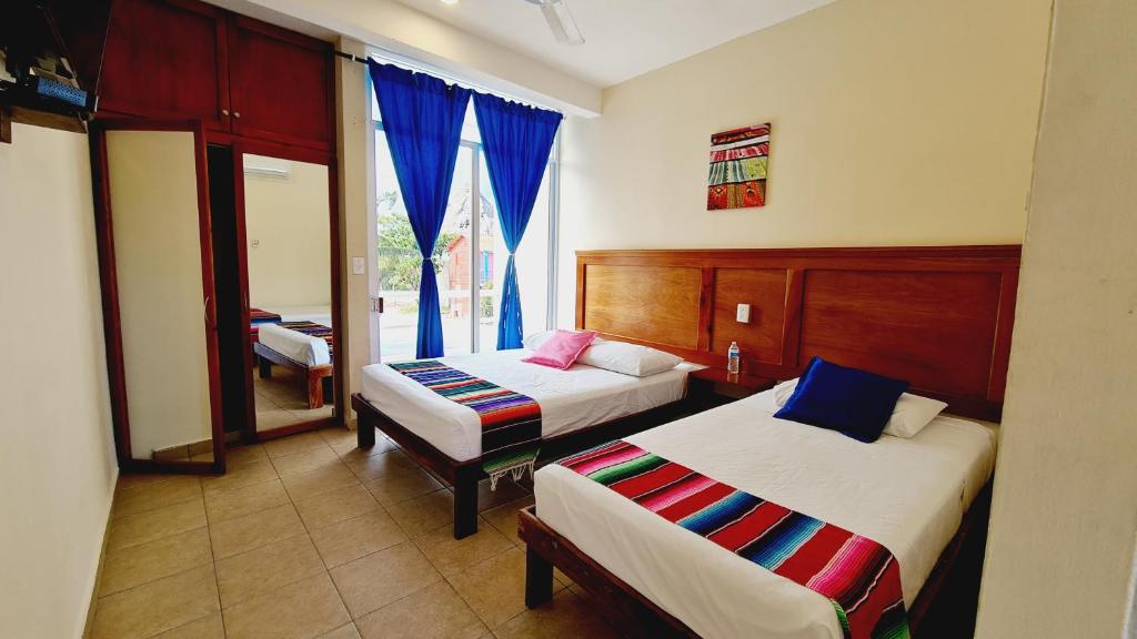 Postel nebo postele na pokoji v ubytování Hotel Machos Mahahual