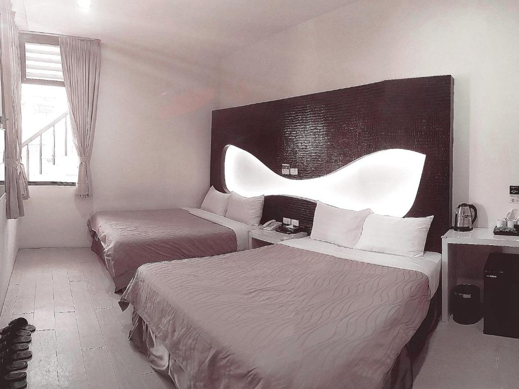 Postel nebo postele na pokoji v ubytování CoCo Motel Boutique