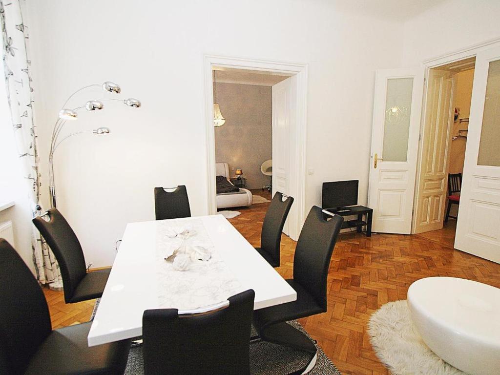 a dining room with a white table and chairs at Ferienwohnung Urban-Loritz in Vienna