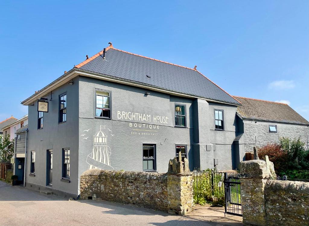 a building with a sign on the side of it at Brightham House in Salcombe