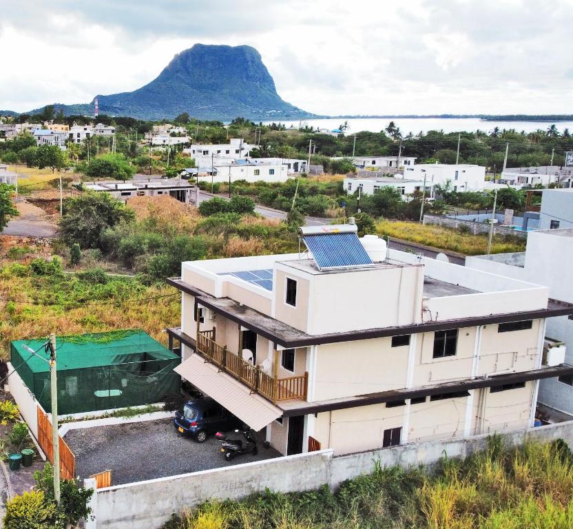 a house with a solar panel on its roof with a mountain in the background at Tenexia - Mountain View in La Gaulette