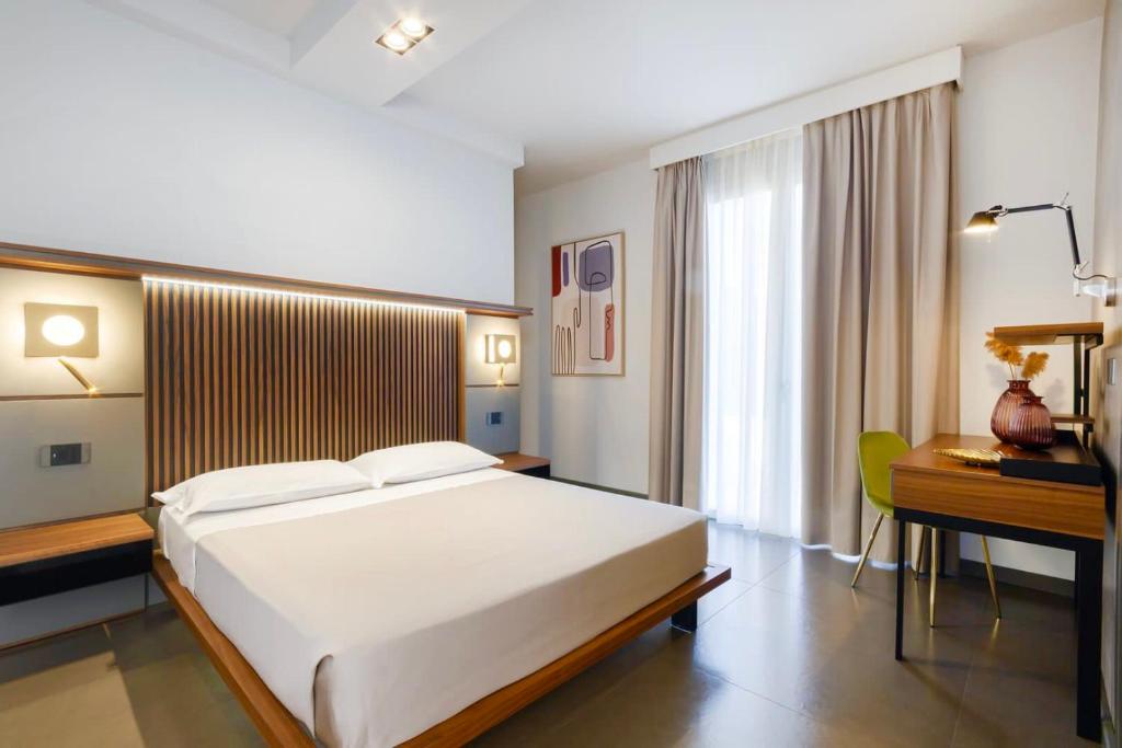 Postel nebo postele na pokoji v ubytování Hotel Vespucci