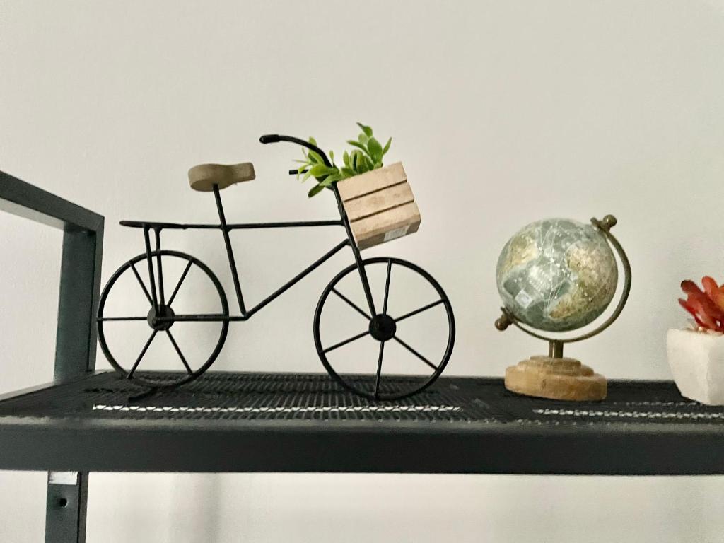a figurine of a bike on a desk with a globe at Arina & Julien Dieppe in Dieppe