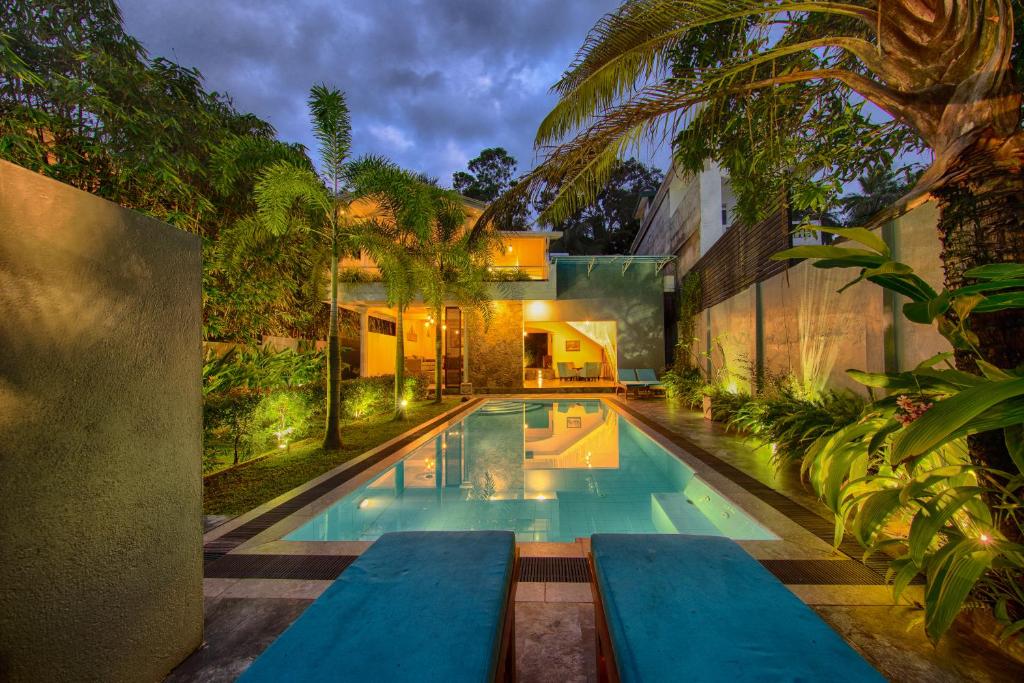 a swimming pool in the middle of a house at Deltora Villa - free drop off to Galle Fort by TukTuk in Galle