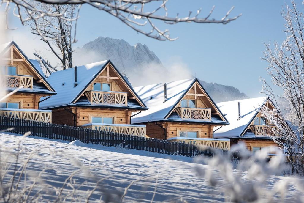 a log cabin in the snow at Osada Chłabówka Zakopane & SPA in Zakopane