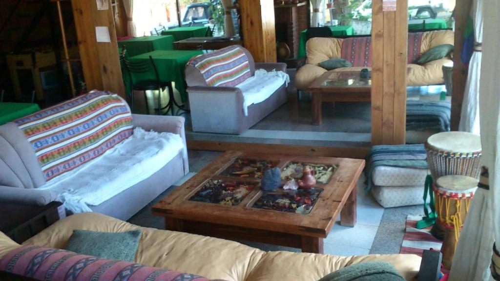 a living room with couches and a coffee table at Hotel La Marina in Villa Carlos Paz