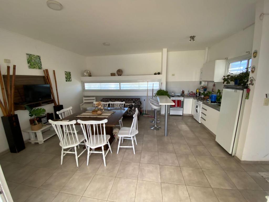 a kitchen and dining room with a table and chairs at Ventanas al Sur in San Nicolás de los Arroyos