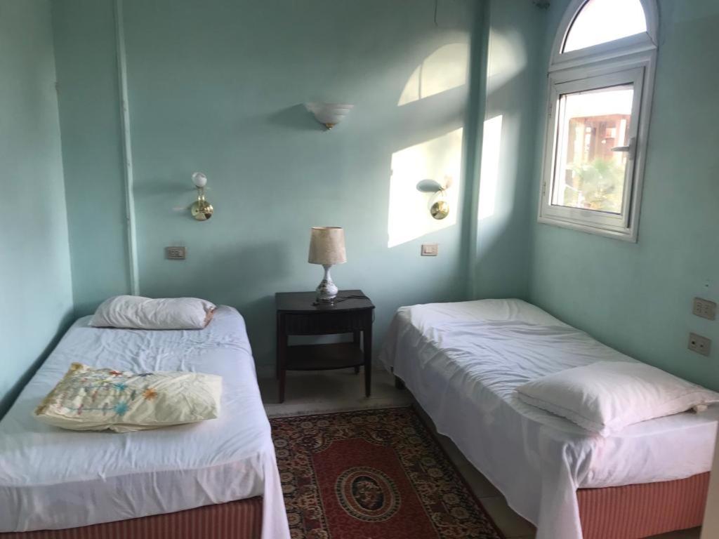 A bed or beds in a room at East Luxor Apartments with Nile views