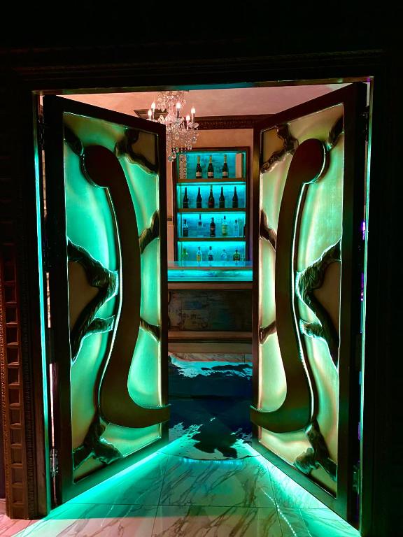 a person is standing in front of a room with green lights at Utopía Alicante - Hotel Boutique para adultos in Alicante