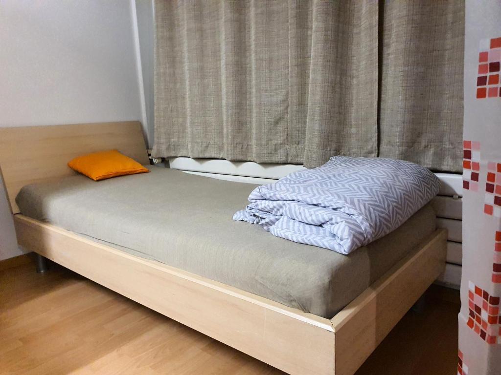 a small bed in a room with a window at Private Bed in a Shared Spacious Apartment in St. Gallen