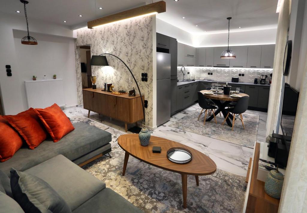 a living room with a couch and a table at LA Larissa Luxury Apartments Kreousa in Larisa