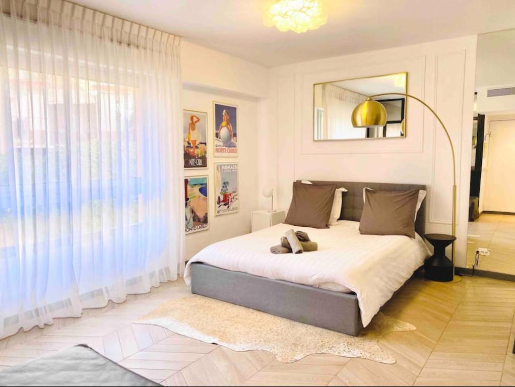 a bedroom with a bed and a large window at Beautiful Fully Renovated Centrally Located Studio in Monte Carlo