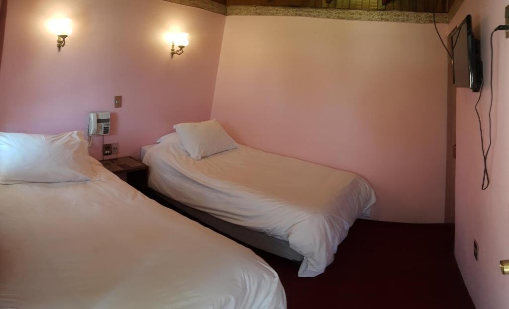 Postel nebo postele na pokoji v ubytování Hotel Cordillera