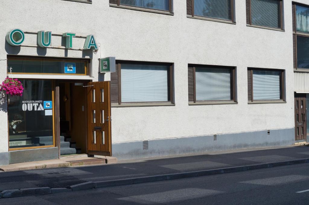 a building with an open door on a street at Guesthouse Outa in Rovaniemi