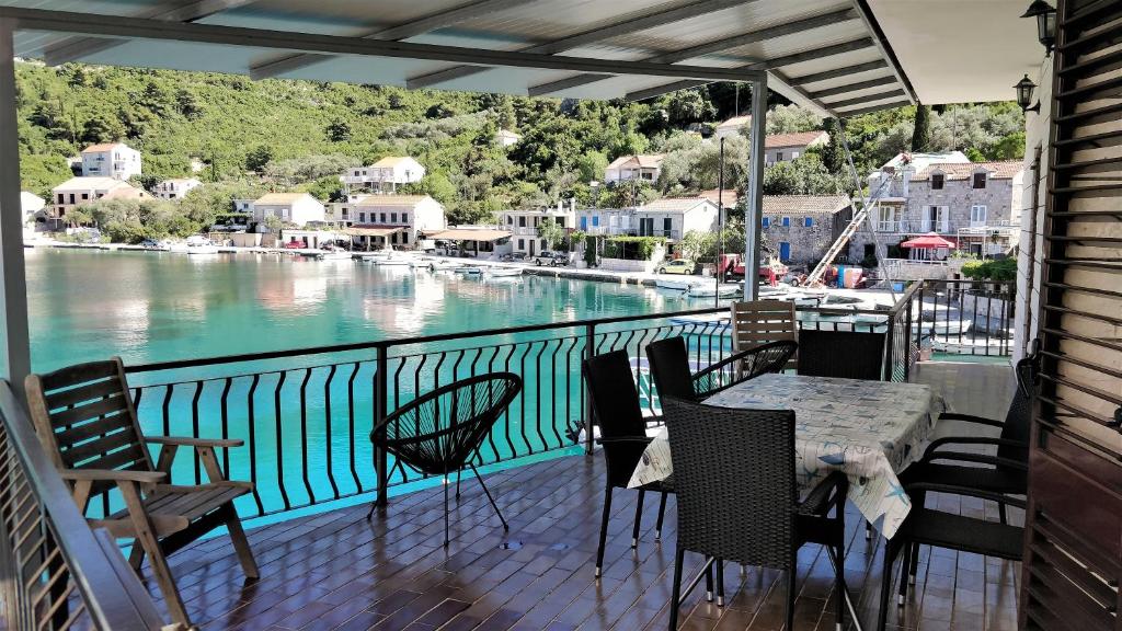 a balcony with a table and chairs and a view of the water at BOCA - 3 Bedroom apartment by the sea in Prožura