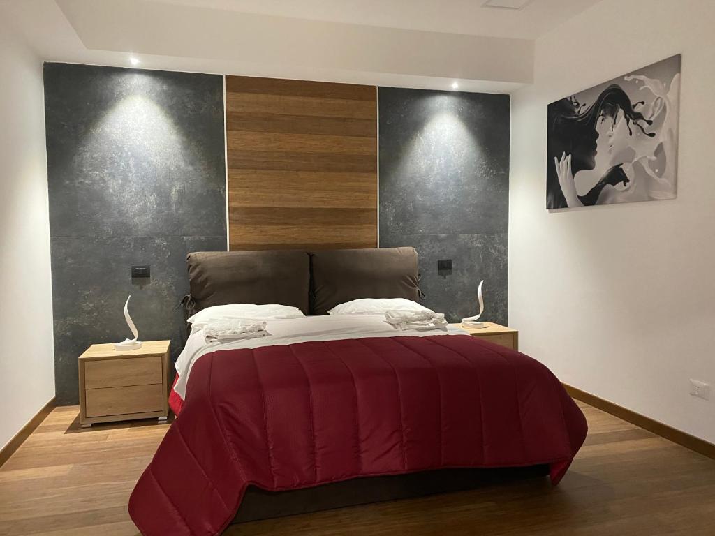 a bedroom with a large bed with a red blanket at Eutuxia in Taranto