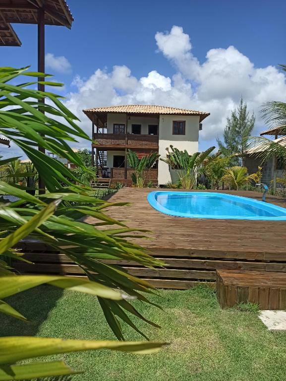 a villa with a swimming pool and a house at Bahia Soul - Bangalô Lua - Grupo Barril Hospedagens in Marau