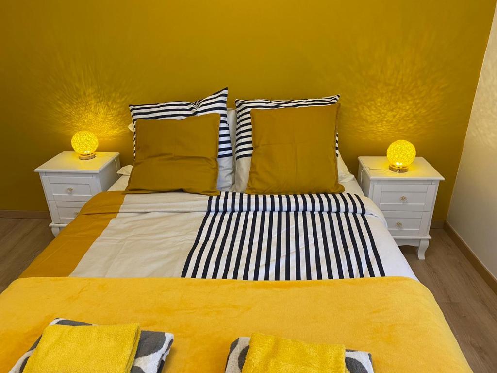 een slaapkamer met een groot bed met 2 nachtkastjes bij Grand F3 de 71m2 en plein centre ville Arpajon in Arpajon