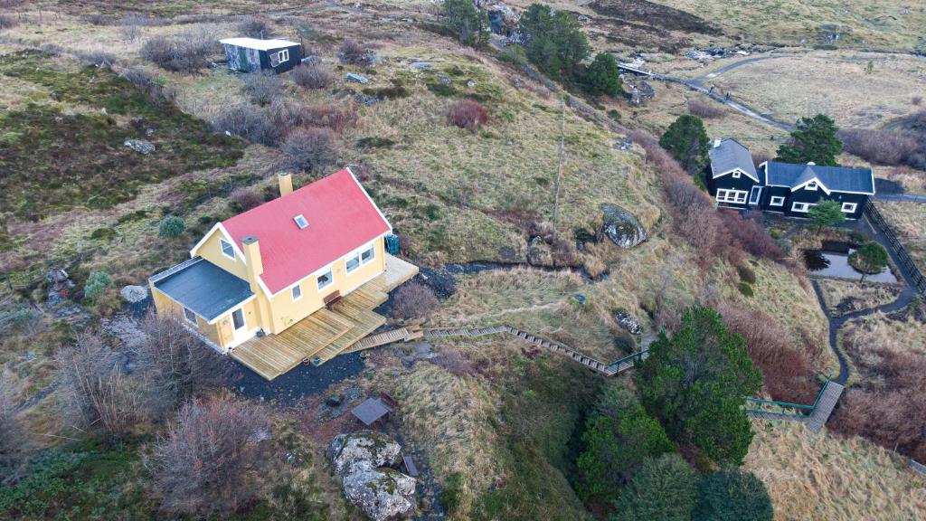 an aerial view of a house on a hill at Red Robin - Vacation homes next to Svartifossur waterfall in Tórshavn