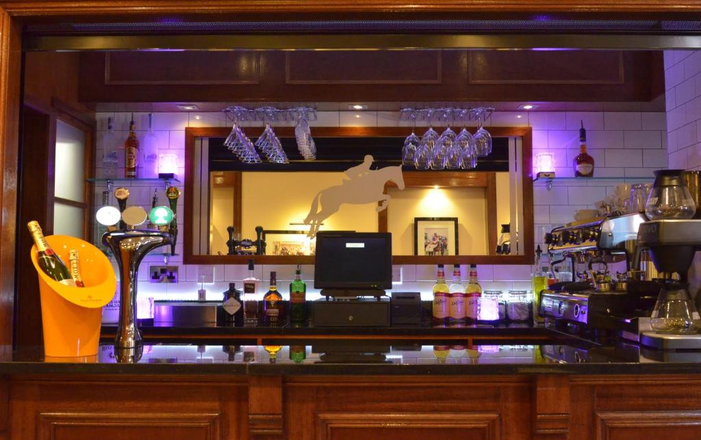 a bar with a reflection of a horse in a mirror at The Ayrshire and Galloway in Ayr