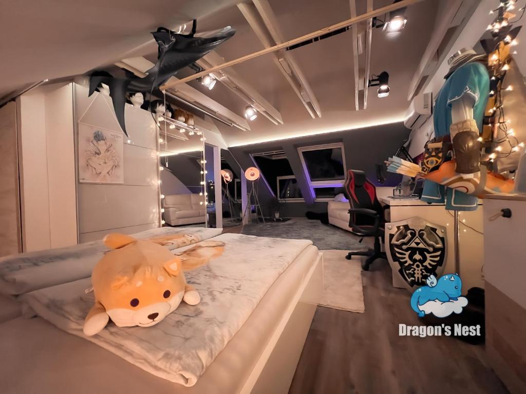 a room with a bed with a stuffed animal on it at Dragon’s Nest: Cozy & modern attic loft Nuremberg in Schwaig bei Nürnberg