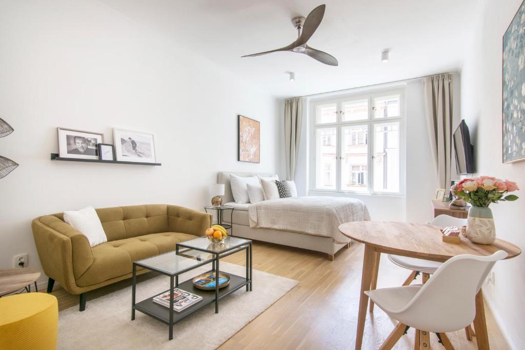 a living room with a couch and a table at Bear Fountain Residence in Prague