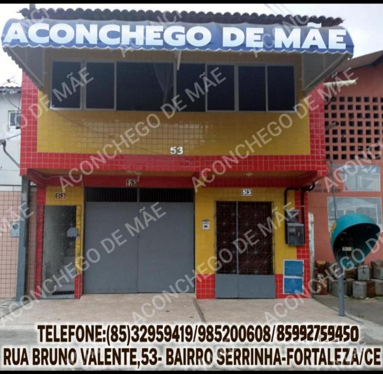 a building with a sign for a mexican restaurant at Pousada Aconchego de Mãe in Fortaleza