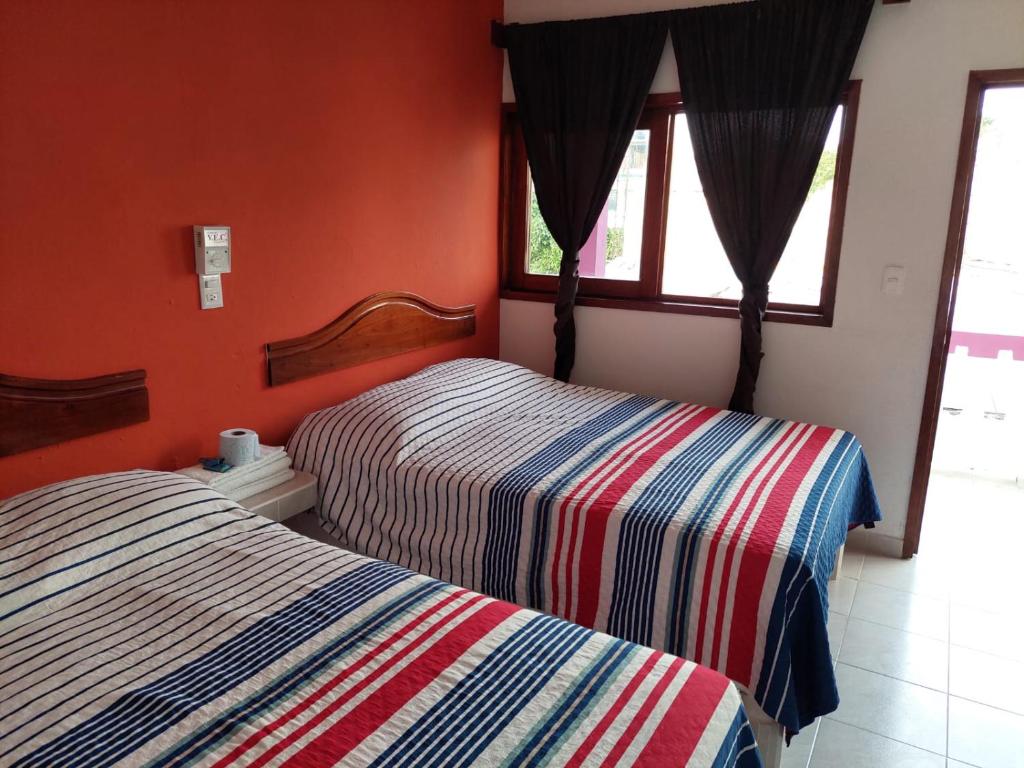 Postel nebo postele na pokoji v ubytování Posada Casa Bugambilias