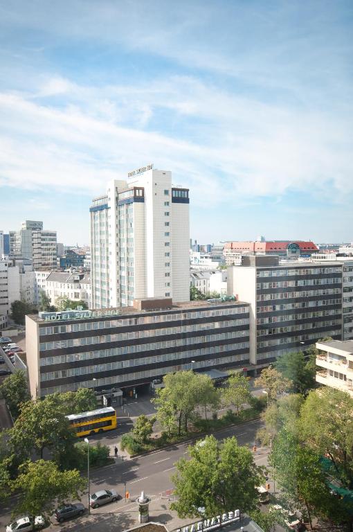 a large building with a parking lot in a city at Sylter Hof Berlin in Berlin
