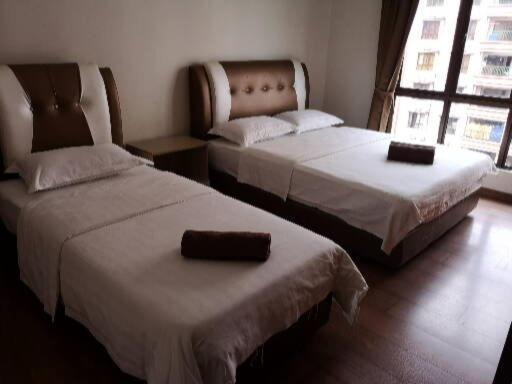Voodi või voodid majutusasutuse Marina Court KK City Homestay toas