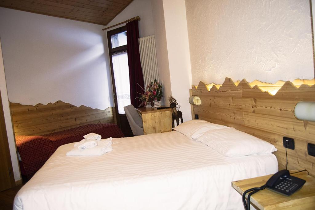 Postel nebo postele na pokoji v ubytování Hotel Cova