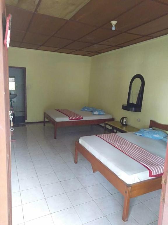 Postel nebo postele na pokoji v ubytování Sibayak Guesthouse
