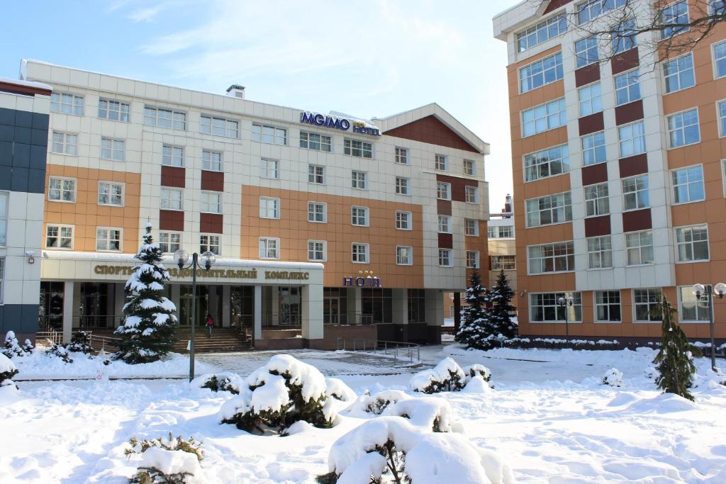 a large building with snow in front of it at MGIMO Hotel in Odintsovo