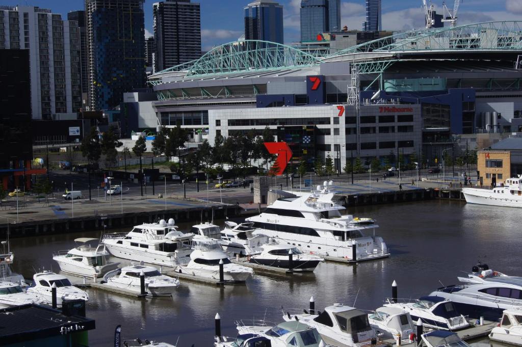 a bunch of boats are docked in a harbor at Docklands Private Collection - NEWQUAY in Melbourne