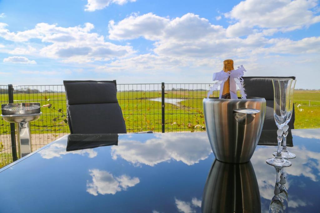 a table with a wine glass sitting on top of it at Heimathafen in Tetenbüll