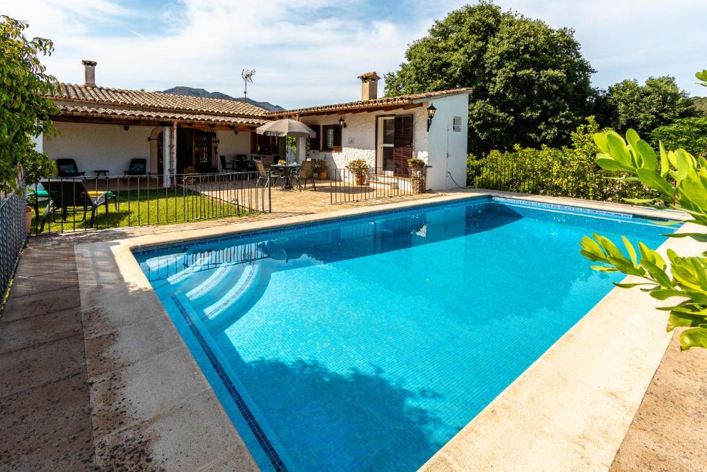 an image of a swimming pool in front of a house at Ca na Miracles in Pollença