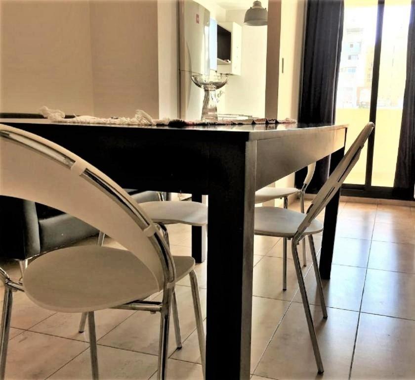 a dining room with a black table and chairs at Dralas Cordoba-General Paz in Córdoba